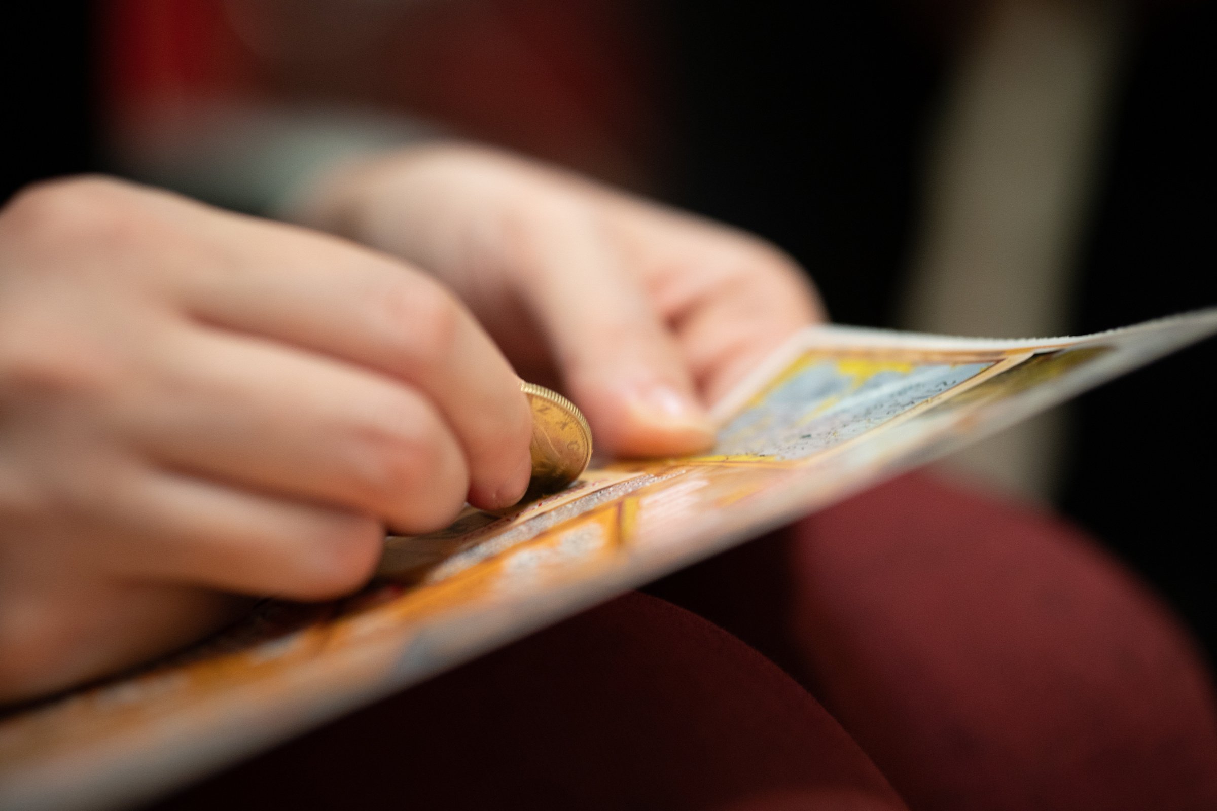 Person Scratching a Lottery Ticket